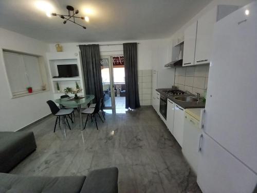 a kitchen and living room with a table and chairs at Tara in Korčula