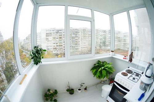 a white kitchen with windows and a stove at Alex Botique in Varna City