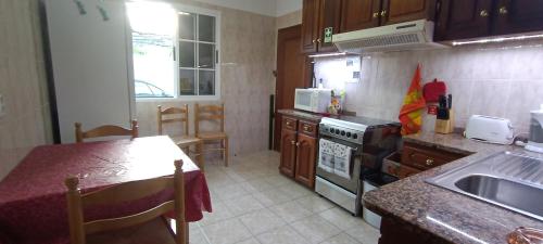 a kitchen with a sink and a stove top oven at Casa Alencastre in Funchal
