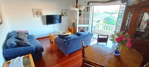 a living room with two blue couches and a table at Casa Alencastre in Funchal