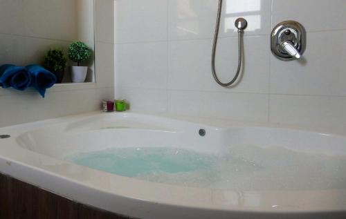 a bath tub filled with water in a bathroom at צימר חספין in Haspin