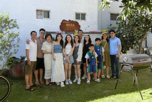 a group of people posing for a picture in front of a house at Villa sân vườn Misa in Phan Thiet