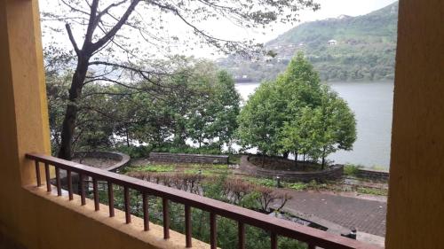 a view of a lake from a balcony at Studio Apartment On The Lake in Lavasa