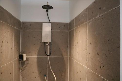 a shower with a shower head in a bathroom at Sorya Guesthouse & Dolphin Tours in Kratie