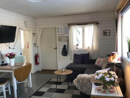 a living room with a couch and a table at Villa Stuga in Hammarstrand