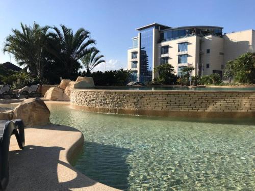 a pool of water in front of a building at Spectacular sea views apartment in Gibraltar