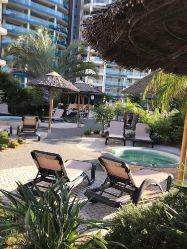 a group of lounge chairs and a swimming pool at Spectacular sea views apartment in Gibraltar
