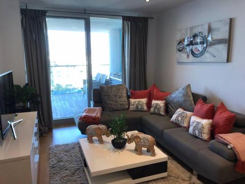 a living room with a couch and a table at Spectacular sea views apartment in Gibraltar