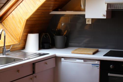 a kitchen with a sink and a counter top at Les rives de l'odet, vue rivière in Quimper