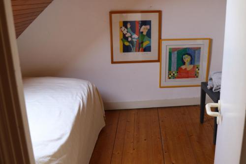 a bedroom with a bed and two pictures on the wall at Les rives de l'odet, vue rivière in Quimper