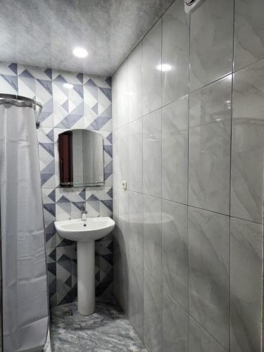 a bathroom with a sink and a mirror at Garni Nature Villa in Garni