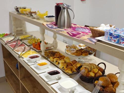 a buffet with many different types of breakfast foods at Khan Hotel Samarkand in Samarkand