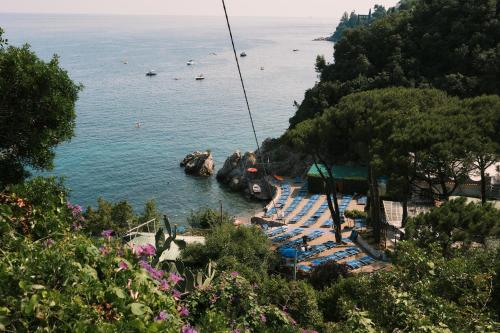 a view of a beach with lounge chairs and the water at villa albori in Vietri sul Mare