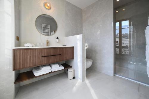 a bathroom with a sink and a toilet and a mirror at Grand Hôtel Du Parc - Teritoria in Aix-les-Bains