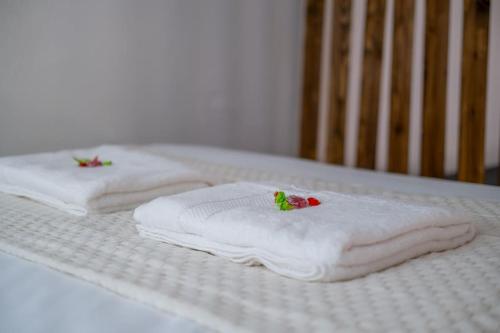 two white towels on top of a bed at Le Brillant - Studio in Reims
