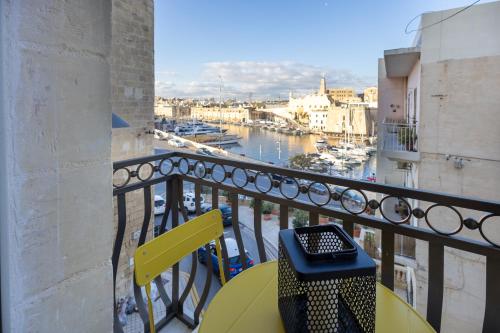 a balcony with a table and a view of a harbor at Sea View 34 in Birgu