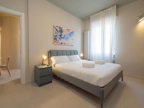 a bedroom with a large bed and a window at [IHost Apartment] - Stendhal 49 in Milan