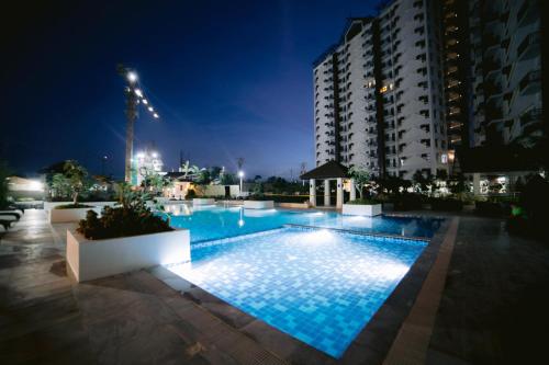 a swimming pool at night with a building at Royal Oceancrest Mactan Condominium Unit 1418 in Sudtungan