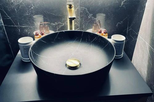 a bathroom with a round bath tub on a counter at Love Room Le Baroque / Jacuzzi / Sauna in Château-Landon
