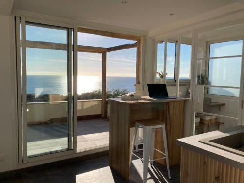 a kitchen with a desk with a laptop on it at Chez Jean Claude la villa des amis in Olmeto
