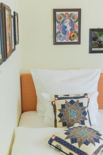 a bed with two pillows and two pictures on the wall at Gästehaus Englischer Garten in Munich
