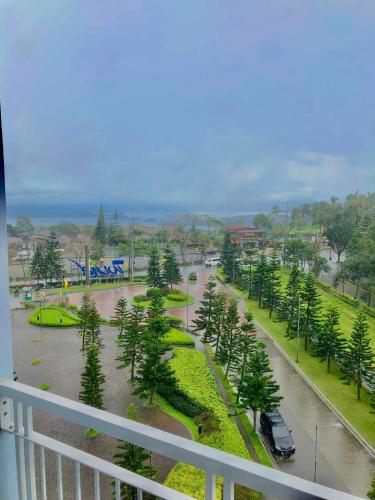 a view of a street with palm trees and a parking lot at JT Tagaytay Suites in Tagaytay