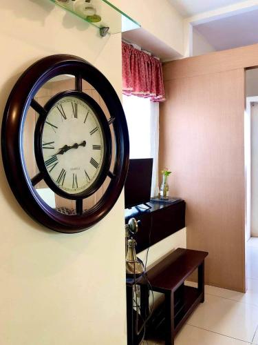 a large clock on the wall in a room at JT Tagaytay Suites in Tagaytay