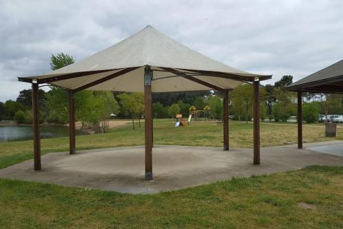 a large tent in a park with a playground at Tipi Apache des monteaux in Vivy