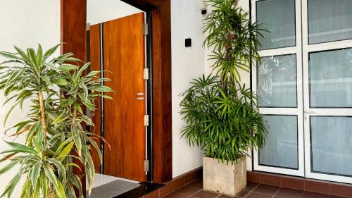 a pair of plants in front of a door at Villa De Lanerolle in Kalutara