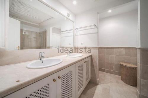 a bathroom with two sinks and a large mirror at Moderno Loft - Beach & Golf in Marbella