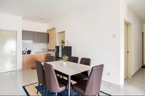 a kitchen and dining room with a table and chairs at Residensi Ostia by ZUJ in Bandar Baru Bangi