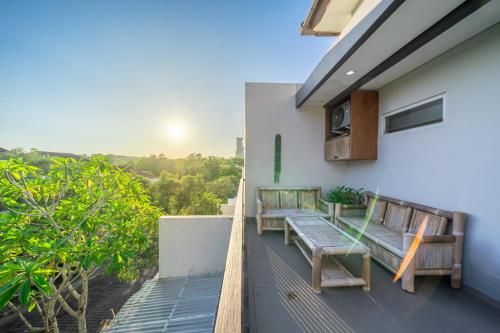 a balcony with benches on the side of a building at iVilla in Jimbaran