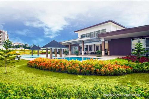 a house with a swimming pool in the yard at JT Tagaytay Suites in Tagaytay