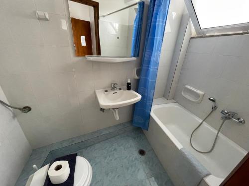 a bathroom with a sink and a toilet and a shower at Studio Bellos in Tolo