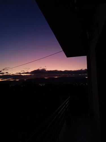 a view of a sunset from a window at Serene Country House (near Ancient Tiryns) in Nafplio