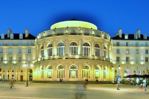 a large building with people walking in front of it at rhoazon heart in Rennes