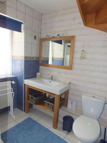 une salle de bain avec un lavabo, des toilettes et un miroir dans l'établissement La gargouille de bricourt : maison de 4 chambres ., à Cancale
