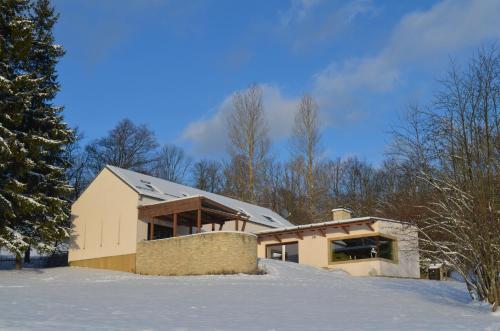 a house in the snow with snow covered ground at Vila Stašov in Polička