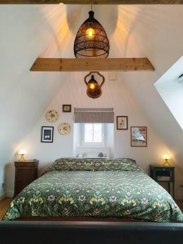 une chambre avec un lit avec une couette verte dans l'établissement Maison de Vacances 1930, à Vannes