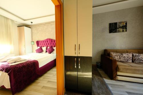 a bedroom with a bed and a couch and a mirror at Taksim Celebi Suites in Istanbul