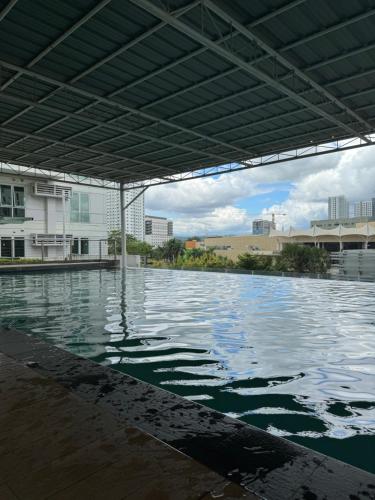 a large pool of water with a building in the background at Abreeza Place T2 - 720 in Davao City