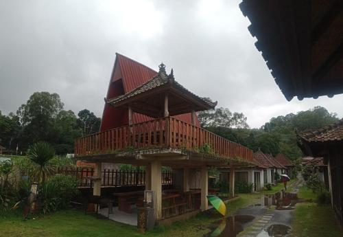 a large building with a red roof at Astradana Hotel & Glamping in Kintamani