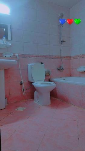 a bathroom with a toilet and a sink and a tub at Live Like A Family Home away from Home near Manila Super Market Opposite SAHARA Center near Al Nahda Park NMC Center Sharjah in Sharjah