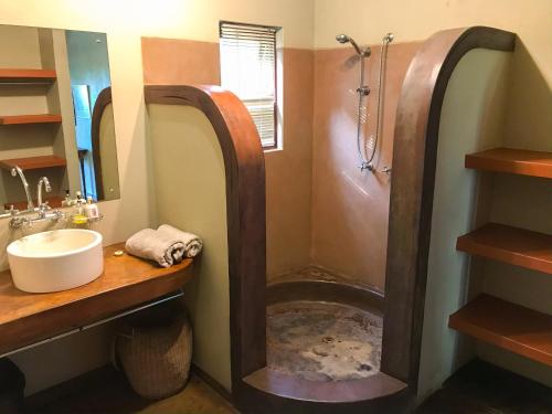 a bathroom with a shower and a sink at Casa Jardim in Vilanculos