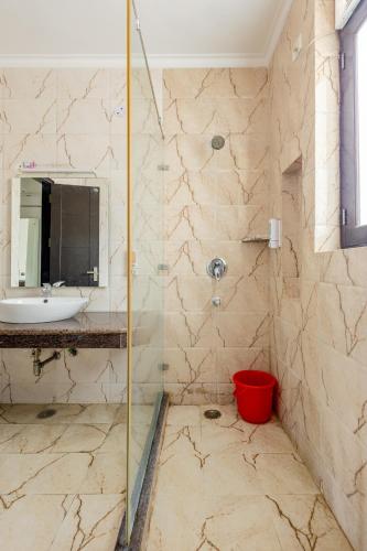 a bathroom with a shower and a sink and a mirror at Lime Tree Service Apartment Golf Course Road, Gurgaon in Gurgaon