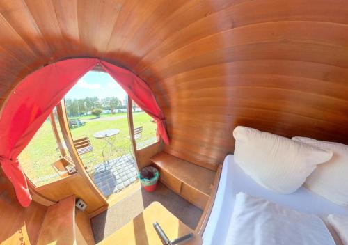 an overhead view of a room with a bed and a window at Rheingau 524 Schlaffassdorf direkt am Rhein in Geisenheim
