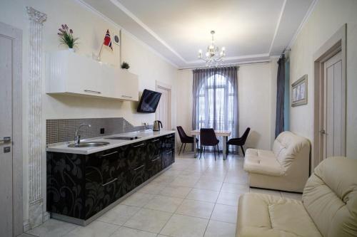 a kitchen and living room with a table and chairs at 2 Bedrooom In CENTER Всегда есть свет ! in Odesa