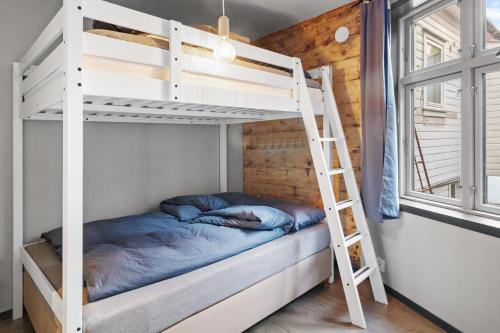 a bunk bed in a room with a ladder at Elegant Urban Apartment in Bergen