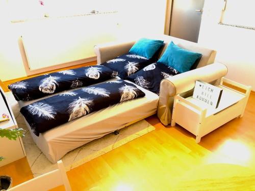 salon z kanapą i niebieskimi poduszkami w obiekcie Modernes Apartment in Waldstetten w mieście Waldstetten