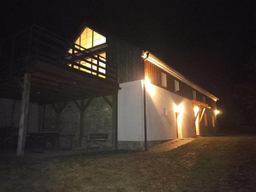 a barn with lights on the side of it at night at Chalupa v Českém lese in Bělá nad Radbuzou